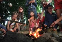 enfants avec handicap autour d'un feu de camp